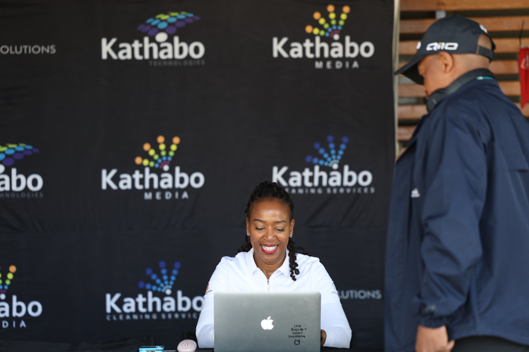 Kathabo Media coordinator managing guest registration at a branded event desk