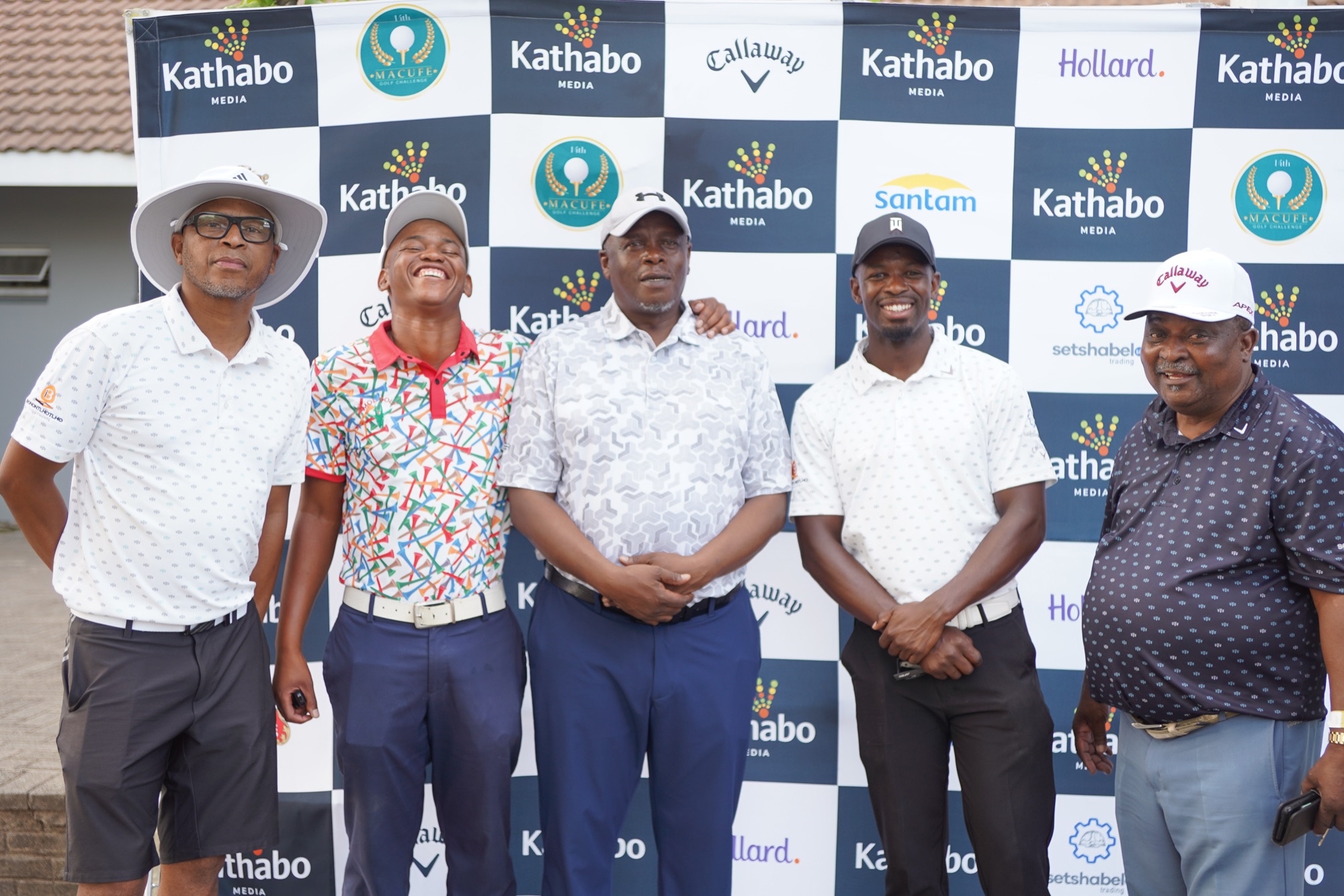 A four-ball team at the Kathabo Golf Challenge media backdrop